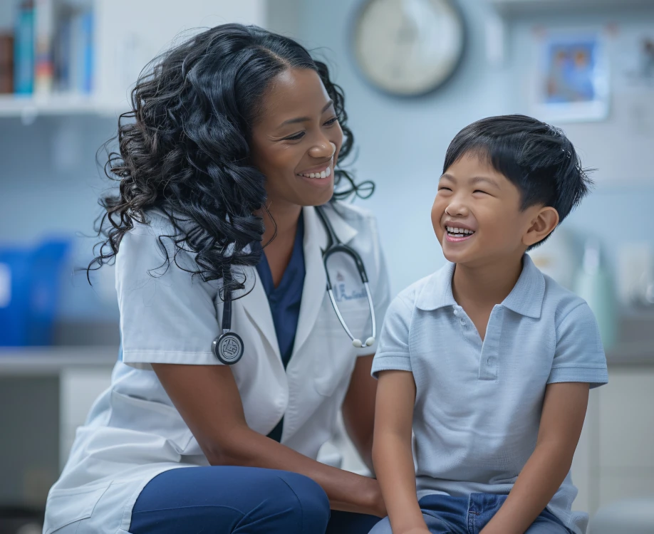 Pediatric nurse practitioner smiling with a child patient